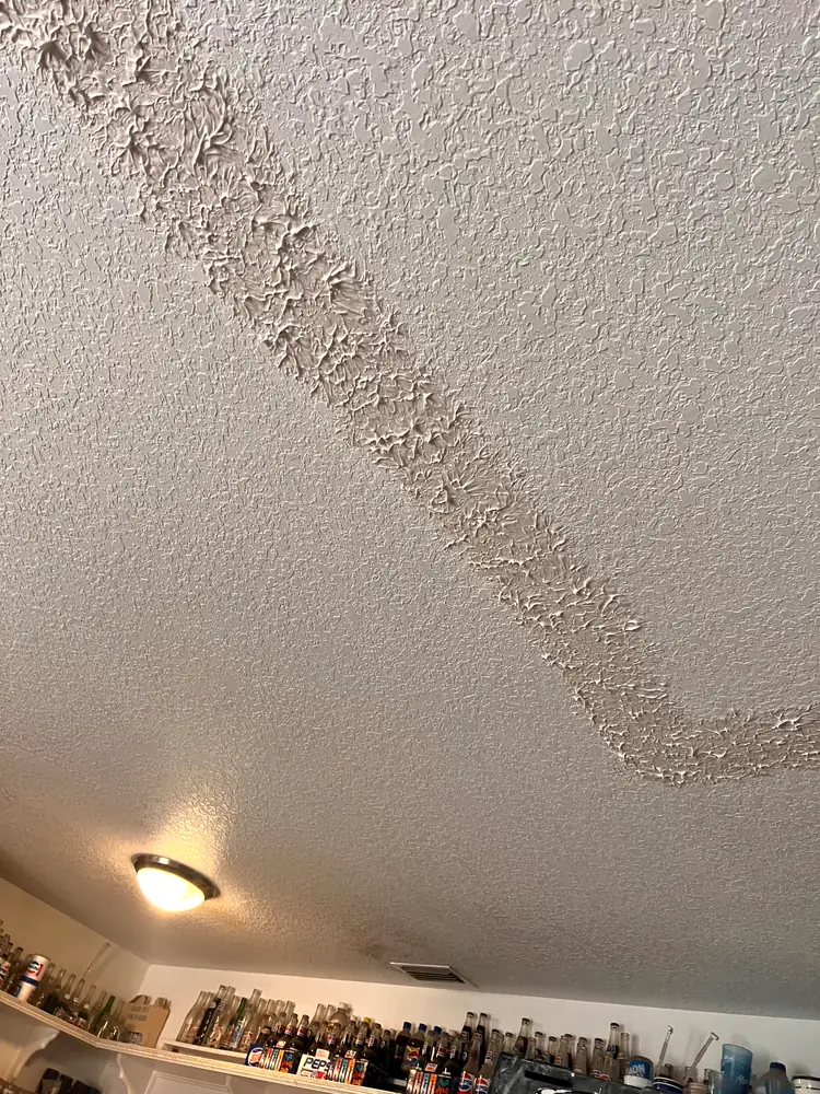 The same ceiling seam re-taped and floated with fresh texture stomped back over it